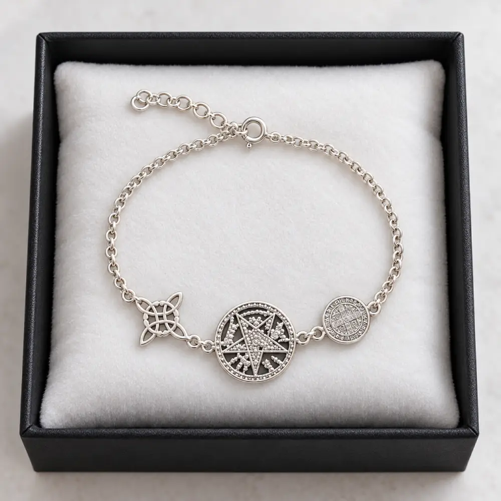 Pulsera Triple Protección de Plata 925 1 Pulsera de cadena de plata 925 con Nudo de Brujas, Pentagramatón y San Benito sobre almohadilla blanca en caja negra.